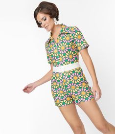 This charming romper is crafted in a green knit boasting pink and yellow daisies and a white trim to flatter your feminine form. Complete with a front zipper, a white sash, and short sleeves.Available in sizes XS-4X while supplies last. Spring Floral Prints, Wardrobe Sale, Belted Romper, Yellow Daisies, Green Outfit, Spring Trends, Pink And Yellow, Short Jumpsuit, Model Pictures