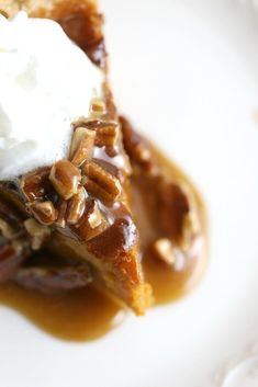 a slice of pecan pie topped with whipped cream