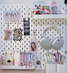 a desk with various items on it including headphones, pens, and other things