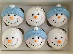 six cupcakes in the shape of snowmen with blue hats and scarves