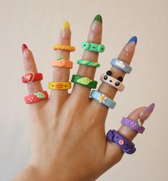 a person's hand with many different rings on their fingers and thumbnails