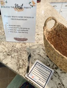 a table with a basket, notepad and pen on it next to a sign that says please write some words of encouraging