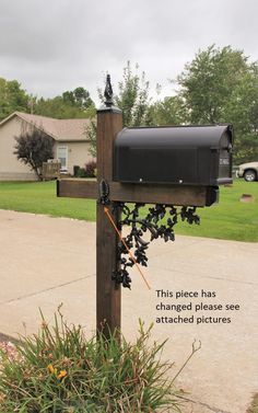 a mailbox is attached to a wooden post