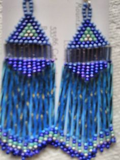 These Earrings are Handmade by Me. Native American, 5 shades of Blue, Blue Iris, Turquoise Iris, Metallic Silver, Czech Seed Beads size 11. 2 mm Silver Lined Bugle Beads "Smokey Blue" and "30mm Silver Lined Twisted Light Blue Bugle Beads with Fringe. They are 3 inches long and 1 and 1/4 inches wide. They are on Sterling Silver Hook Wires with Rubber Backs. They are Dangle Type Pierced Earrings, Handmade. I have one pair in stock. Made to Order means I will make a pair for you within 3 days after Blue Long Drop Beaded Earrings As Gift, Blue Long Drop Beaded Earrings For Gift, Blue Earrings With Dangling Beads, Unique Blue Earrings With Dangling Beads, Unique Blue Long Drop Earrings, Blue Long Drop Chandelier Earrings, Blue Long Drop Chandelier Earrings As A Gift, Beaded Earrings Native American, Earrings Native American