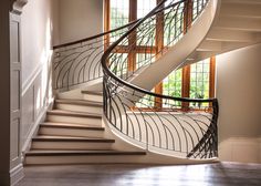 a spiral staircase in a house with windows