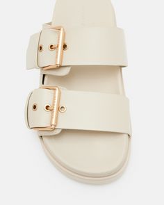 Warmer days are here - the Sian Sandals are perfect for city strolls. Featuring a thick sole with two chunky straps and matte black buckles. Our signature is on the side, it's a subtle addition.      Flats Two straps Slip on Buckle detail Matte black hardware AllSaints 01-11-94 branding If you are between sizes, we recommend sizing up Leather Slides With Adjustable Strap, Flat Shape, Casual Leather Slides With Tang Buckle, Modern Double Strap Slides With Buckle Closure, Casual Leather Footbed Sandals With Tang Buckle, Modern Flat Footbed Sandals With Buckle Closure, Modern Flat Heel Footbed Sandals With Buckle Closure, Modern Footbed Sandals With Buckle Closure, Casual Flat Footbed Sandals With Tang Buckle, Everyday Flat Heel Sandals With Buckle Closure