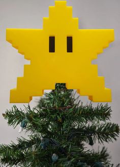 an ornament made to look like a pacman on top of a christmas tree