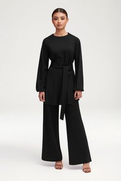 Effortlessly elevate any occasion with the Fatima Everyday Wide Leg Jersey Pants in Black. Crafted from luxurious jersey fabric, these pants offer a sophisticated and exclusive touch. The wide leg design creates a flattering silhouette, making these pants perfect for any event. Elevate your wardrobe with these versatile and elegant pants. Model is 5'6" and is wearing size XS. Elegant Pants, Elegant Pant, Pants Model, Jersey Hijab, Jersey Pants, Leg Design, Jersey Top, Balloon Sleeves, Get The Look