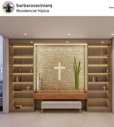 the interior of a modern living room with built in bookshelves and a cross