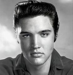 a black and white photo of a man with short hair wearing a button up shirt