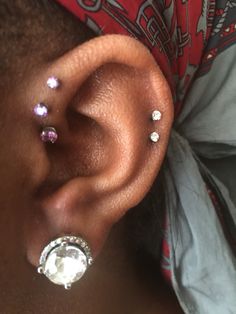 a close up of a person with ear piercings on their left and right sides