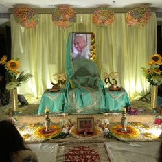 a man is sitting on a throne surrounded by sunflowers and other flowers in front of him