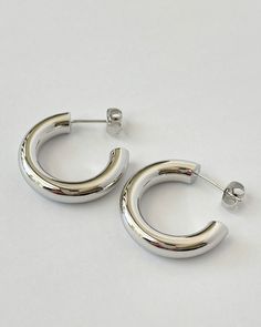 Silver French Girl Hoops. Introducing our stunning Silver hoop earrings, the perfect accessory to elevate any outfit. Crafted from high-quality Silver-plated material, these earrings are lightweight and comfortable to wear all day long. The classic hoop design is versatile and timeless, making it a must-have addition to your jewelry collection. The earrings feature a secure push-back closure to ensure they stay in place. Whether you're dressing for a special occasion or adding a touch of eleganc Modern Silver Hoop Earrings For Everyday Luxury, Trendy Small Hoop Earrings In White Gold, Silver Small Hoop Earrings For Daily Wear, Silver Hoop Earrings Tarnish Resistant For Everyday Luxury, Silver Hoop Earrings For Everyday Luxury, Silver Small Hoop Earrings For Everyday Luxury, Everyday Luxury Small Silver Hoop Earrings, Hoop Design, French Girl