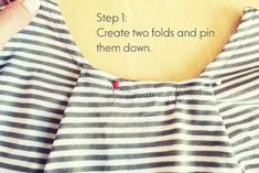 someone is sewing on a striped dress with the words, step 1 create two folds and pin them down