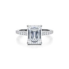 an emerald cut diamond ring with pave set shoulders