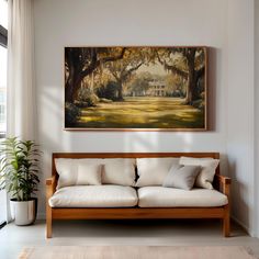 a painting hanging on the wall above a couch in a living room with white walls