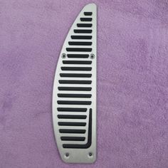 a metal grate sitting on top of a purple blanket