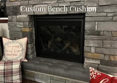 a stone fireplace with pillows on it and a sign that says custom bench cushion above the fire place