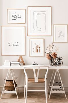 a white desk with some pictures on the wall