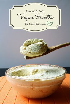 a wooden spoon with some food in it on top of a bowl and the words almond & tofu vegan ricotta above it