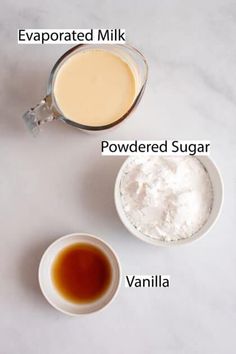 ingredients to make vanilla ice cream on a white counter top, including powdered milk, sugar and vanilla