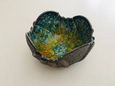 a green and yellow bowl sitting on top of a table