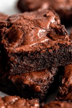 chocolate brownies are stacked on top of each other with one bite taken out of it