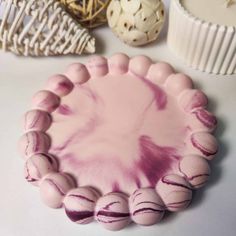 a pink and white cake sitting on top of a table