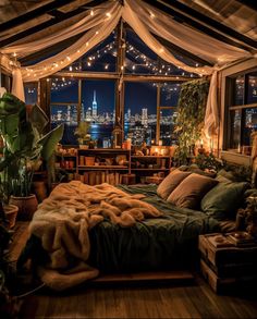 a bedroom with a view of the city at night