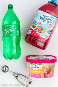 the ingredients to make hawaiian punch are displayed on a white surface, including an ice cream scooper and a bottle of water