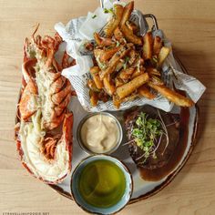 lobster, fries and dipping sauce on a plate