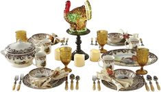 a table set with dishes, silverware and candlesticks is shown in this image