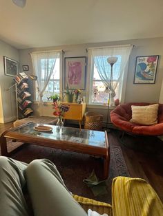 a living room filled with furniture and lots of windows