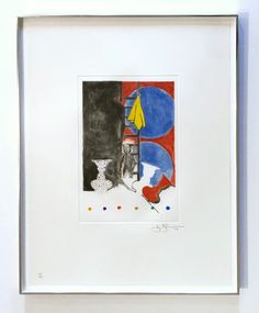 a painting hanging on the wall in front of a white framed art piece with blue, red and yellow shapes