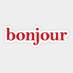 the word bonjour in red and white sticker on a light grey background