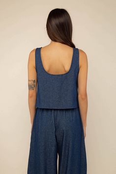 Center front tie sleeveless denim blouse. Designed and made in Los Angeles from locally sourced fabric. Locally sourced Washed Lightweight Denim Cut and sewn ethically, in-house at our factory in DTLA Fit Cindy is 5'4" and wearing size Small View full Size Chart Content & Care 100% Cotton Machine wash cold. Tumble dry low. Casual Sleeveless Denim Blue Crop Top, Dark Wash Sleeveless Casual Top, Summer Denim Vest In Dark Wash With Relaxed Fit, Dark Wash Cotton Denim Vest For Summer, Summer Dark Wash Relaxed Fit Denim Vest, Dark Wash Sleeveless Top For Spring, Casual Summer Tencel Blouse, Spring Sleeveless Top In Dark Wash, Sleeveless Denim Blue Crop Top For Summer