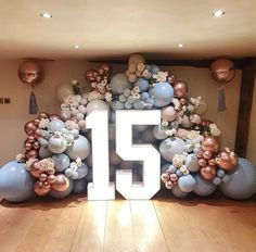 the number fifteen is surrounded by balloons and flowers