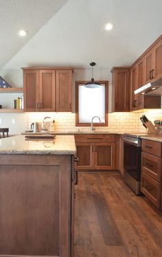 a kitchen with wooden cabinets and an island