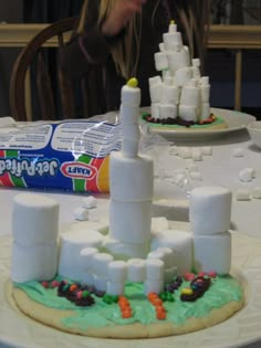 there is a cake made to look like a castle on top of a table with marshmallows