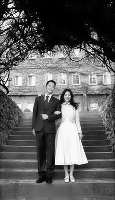 a man and woman are standing on some steps