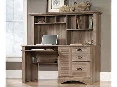 a wooden desk with drawers and a laptop on it