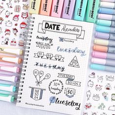 a notebook with markers and stickers next to it