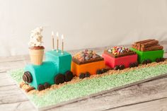 a cake shaped like a train with ice cream on top