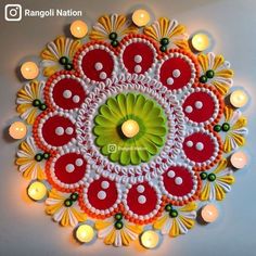 this is an art work with candles on the wall and in the center it is decorated with red, white and green colors