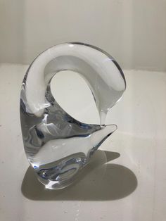 a glass sculpture sitting on top of a white table