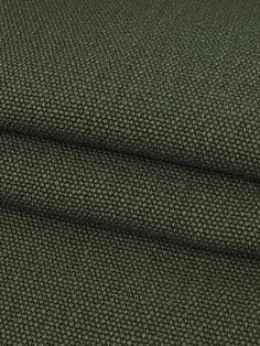 a green fabric textured with small dots on the top and bottom, as well as an