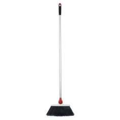 a black and white broom with red handle