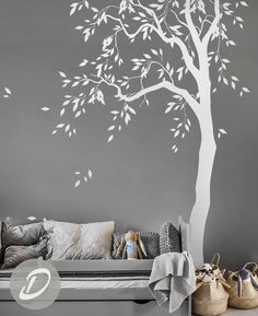 a white tree with leaves on the branches is shown in this living room wall decal