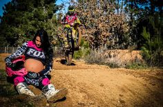 two people on dirt bikes in the woods