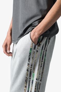 the Hunter Camo Stripe Sweatpants are designed with a relaxed fit throughout, featuring an elasticized self waist, tonal cotton drawstrings, standard hem at the leg opening, hunter camo patterned stripes at the outseam, and finished with a vintage wash. details relaxed fit 100% cotton model is 6’1, 140 lbs and wears a size medium Sporty Camouflage Cotton Bottoms, Camouflage Cotton Joggers With Pockets, Cotton Joggers With Side Stripes, Camouflage Relaxed Fit Bottoms With Elastic Waistband, Casual Camouflage Cotton Sweatpants, Camouflage Cotton Sweatpants For Streetwear, Camouflage Cotton Bottoms With Elastic Waistband, Striped Sweatpants, 140 Lbs